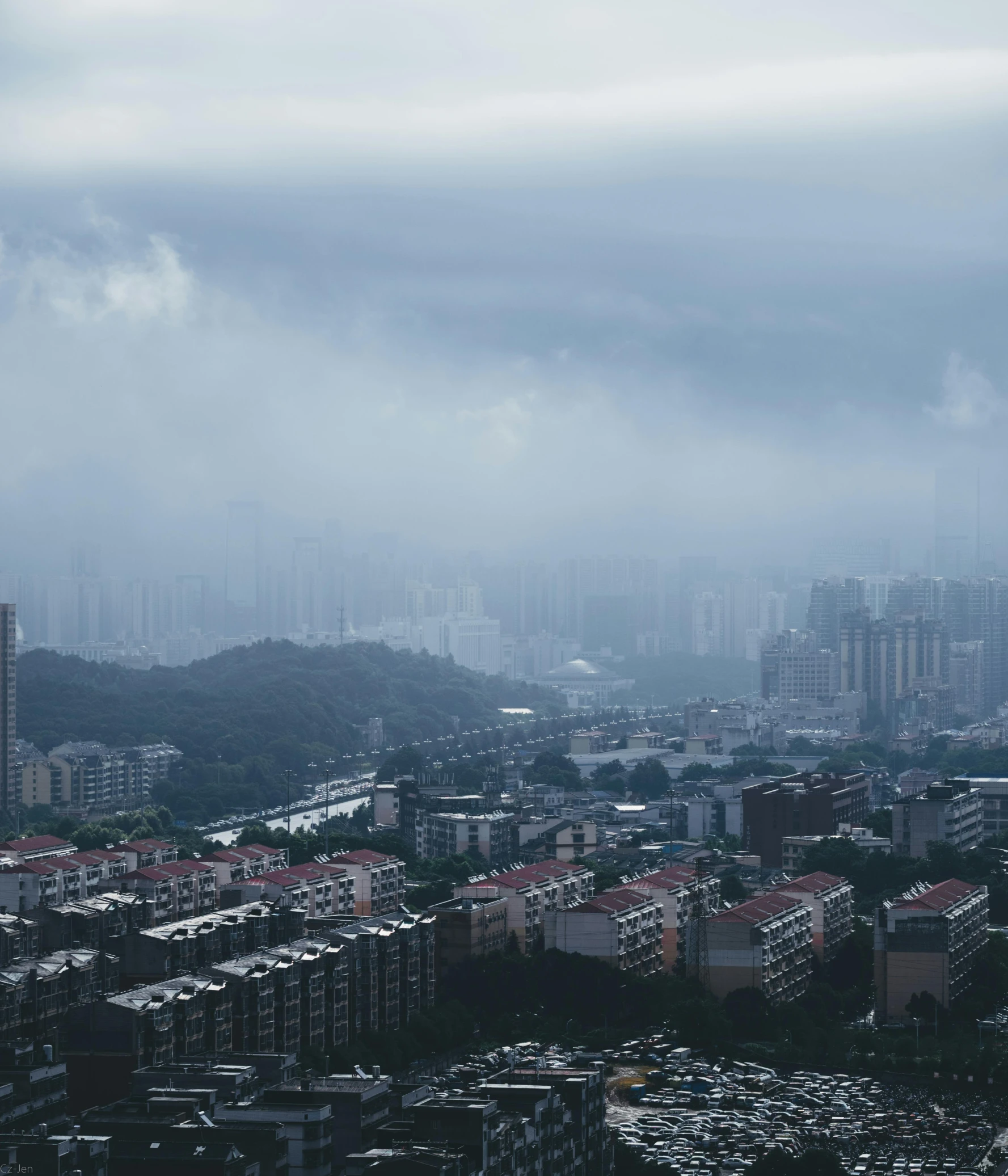 a very tall and grey building towering over a city