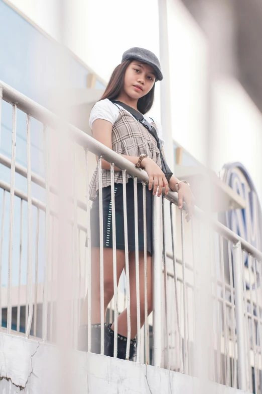 a woman in high heels is looking over a fence