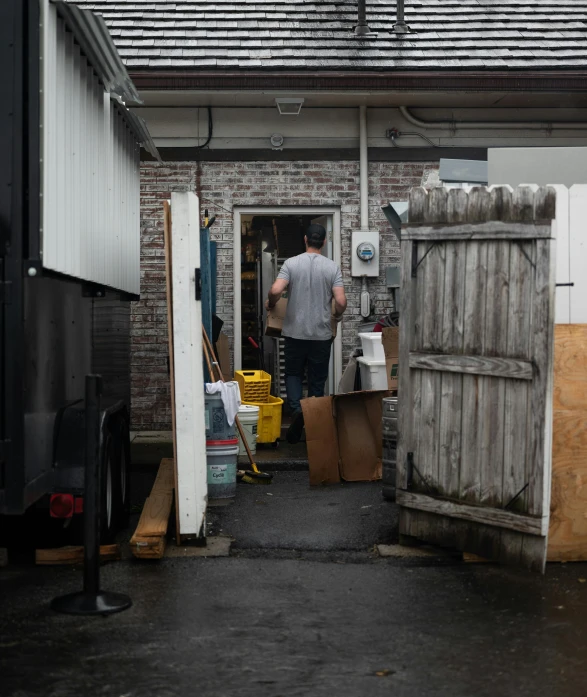 a person in a house next to a doorway