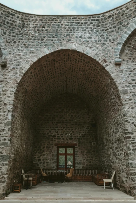 a walkway leading to a doorway surrounded by brick