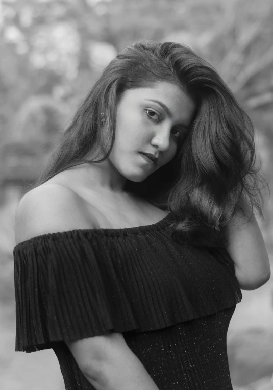 a young woman poses in black and white