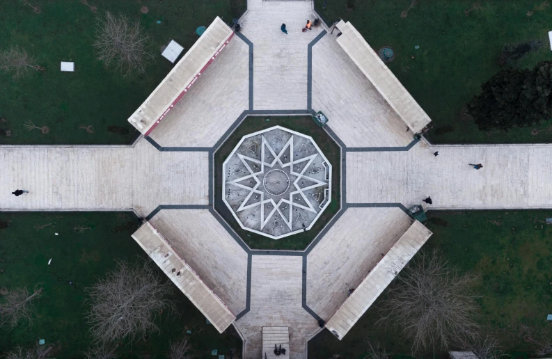 an aerial view of a cement circle with a sculpture in the center
