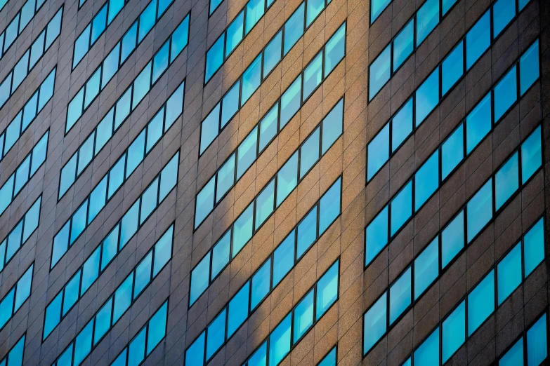 a tall building with many windows and some red stop signs