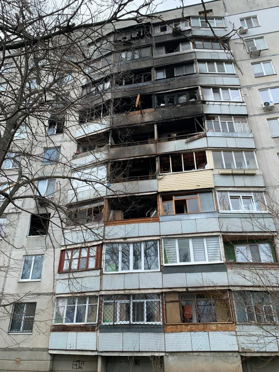 a tall building with multiple windows that are partially open