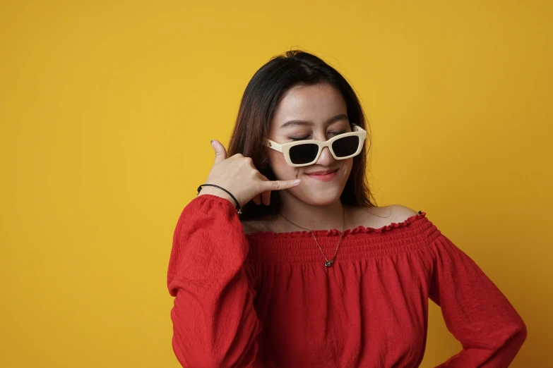 a woman posing for a po wearing sunglasses