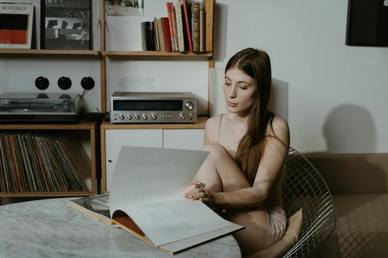 a  girl sits in front of a record