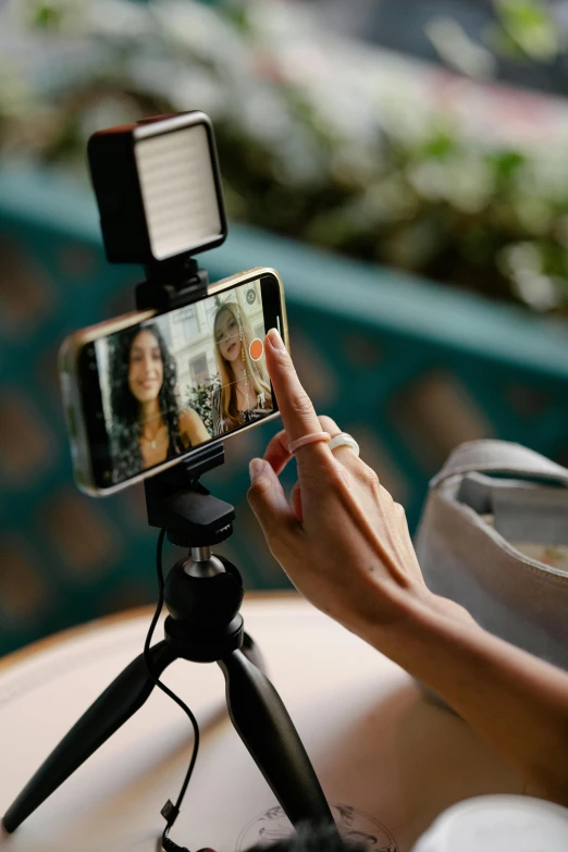 a person taking a po of two women on their phone