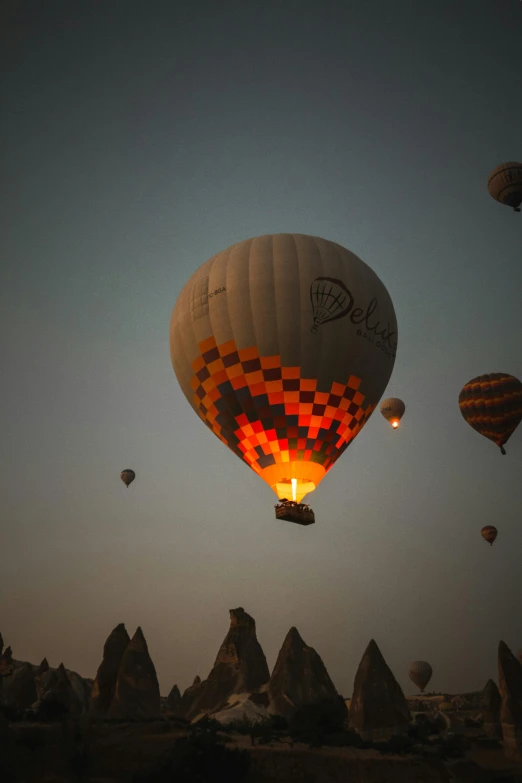 many  air balloons float over the mountains