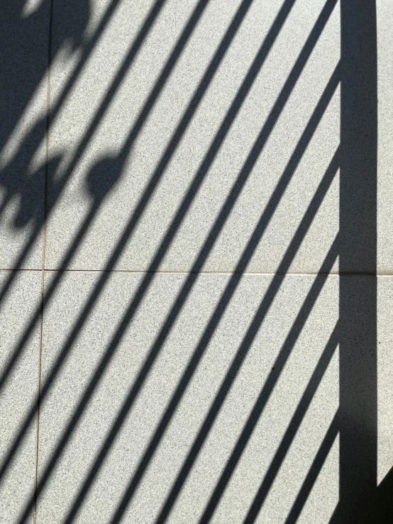a streetlight and some shadow on a wall