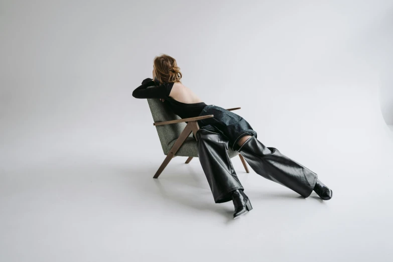 a woman sitting in a chair looking back