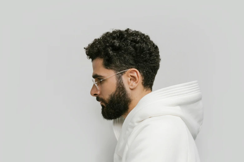 a young man with a beard, glasses and a sweatshirt