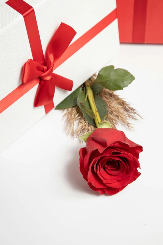 a red rose and a white box for it