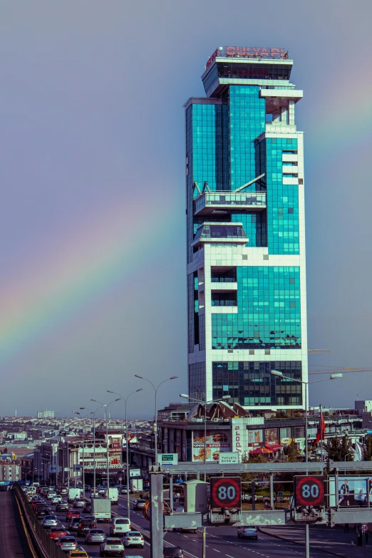 a large tall building in the middle of a traffic intersection