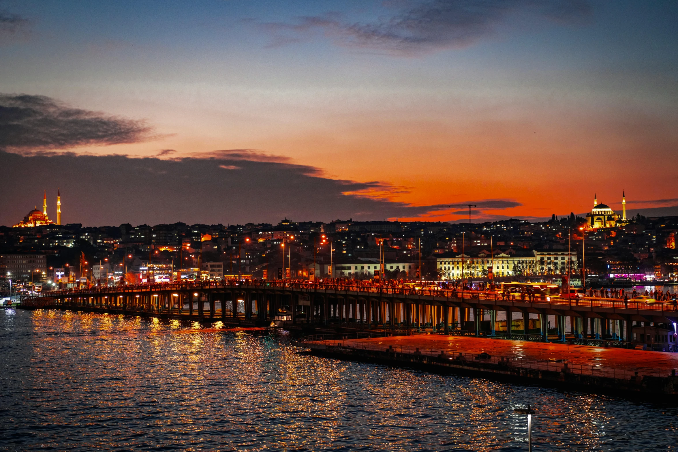 a very pretty night view of a big pretty city by the water