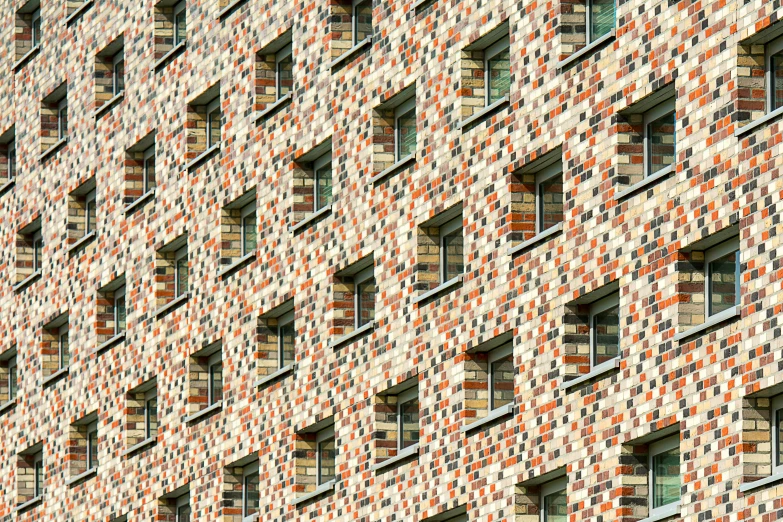 windows in a brick building with orange and white tiles