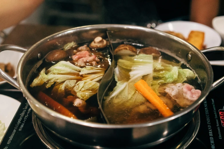 a pot full of soup on top of a stove