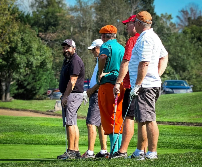 several men with crutches talking and golfing