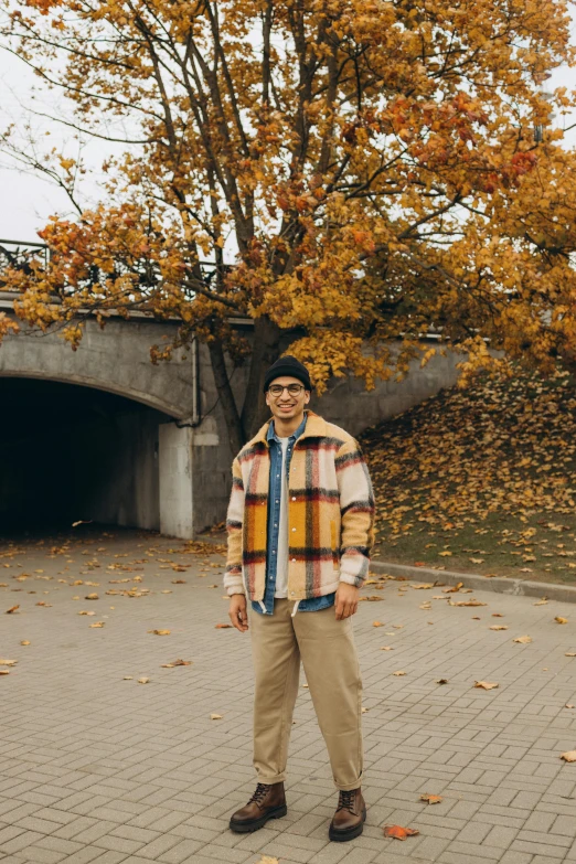 a man standing outside on a brick pavement