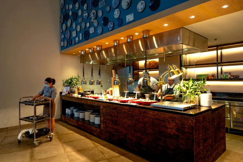 the waiter stands in front of the buffet of the restaurant