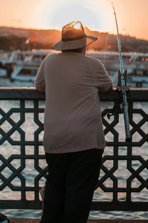 a woman fishing with the setting sun in the background