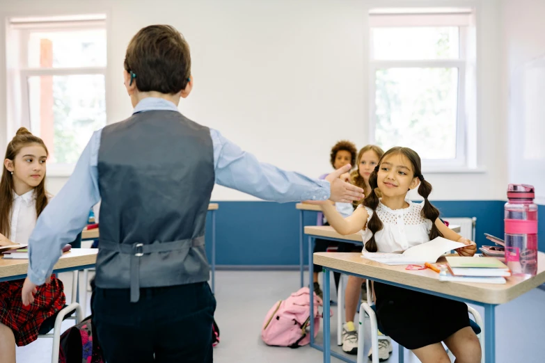 a classroom full of students sitting in desks