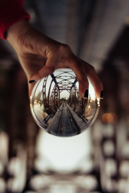 a person is holding up their hand to show their reflection