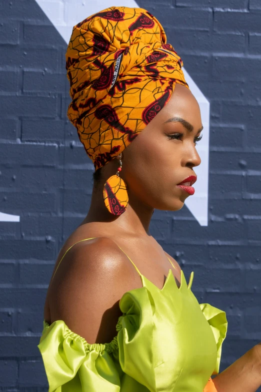 a woman with an orange head scarf on