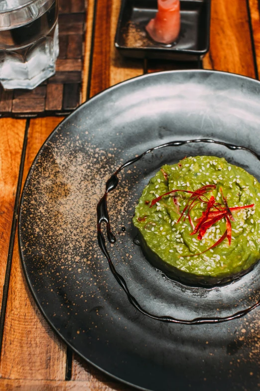 a plate with sauce is shown on a wooden table