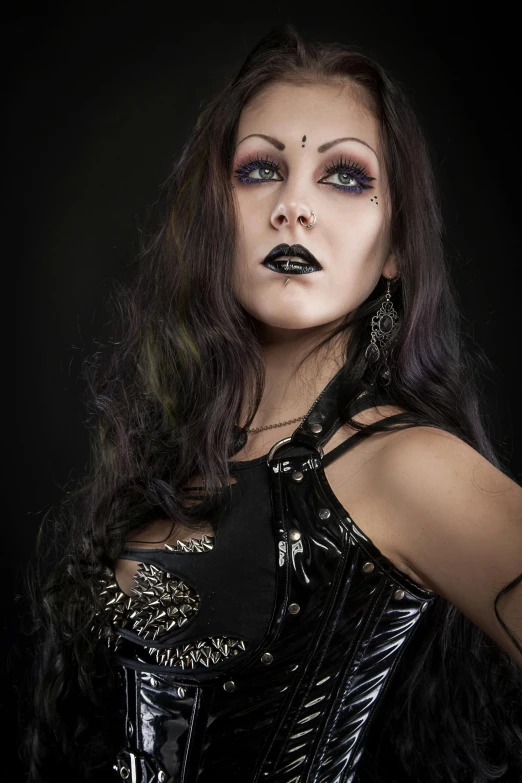 a beautiful young woman with dark makeup and piercings