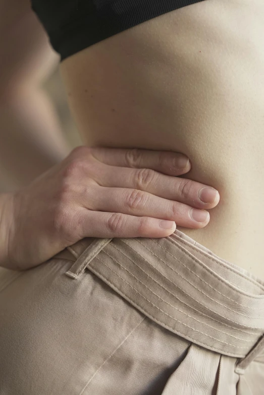 a woman holding her stomach with both hands