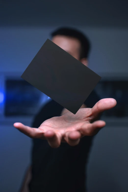 a person with his hands open and holding a black object