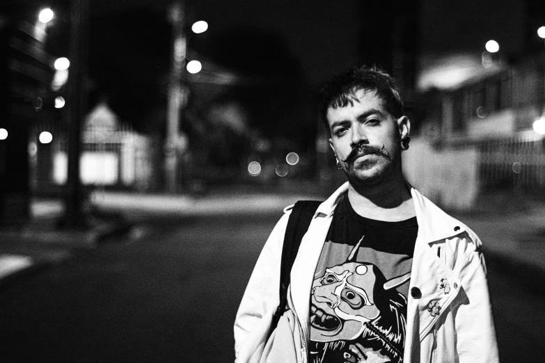 a man standing on a sidewalk next to a street