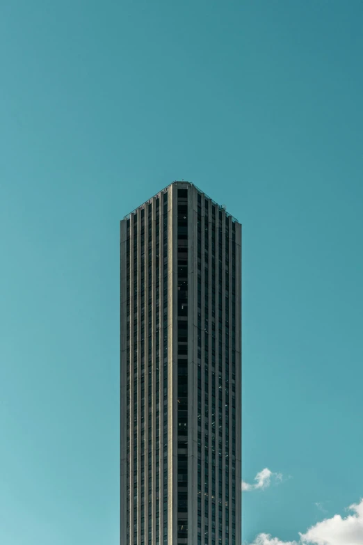 the tops of two skyscrs are seen against the blue sky