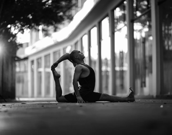 a person sitting on the floor doing yoga