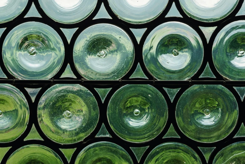 a window with multiple glass vases in the center