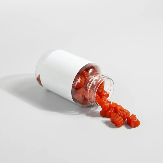 a small bottle of candies on white surface