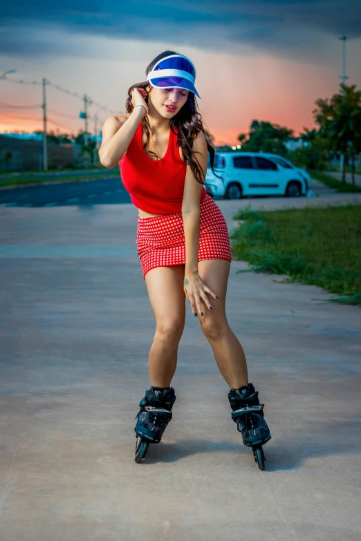 a young woman poses with roller skates on the sidewalk