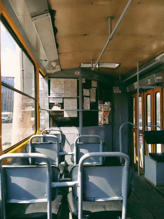 an empty train compartment with chairs and railings