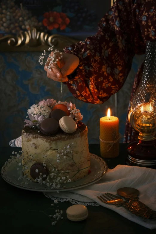 a fancy cake is being poured with candles and flowers