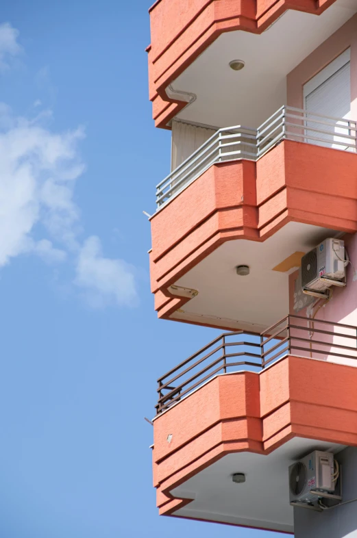 an orange building that has a sky line behind it