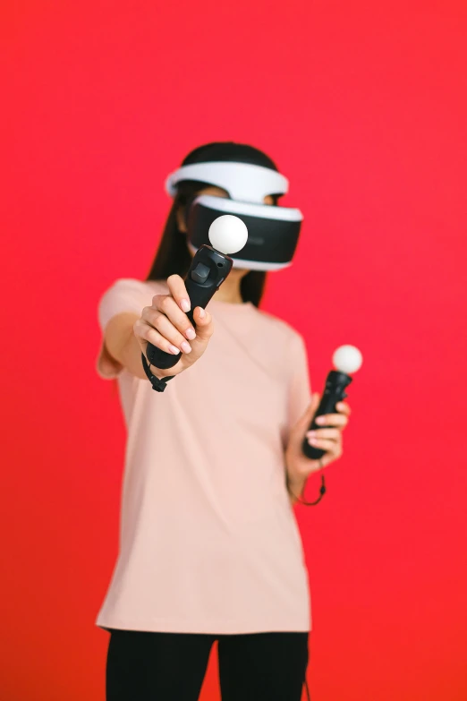 a woman is holding some blow dryers and using a virtual helmet