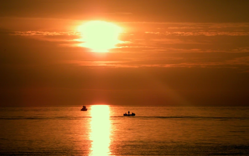 two boats in the distance with a sky background