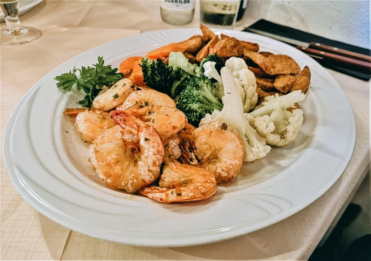 the shrimp and vegetable plate is on a table