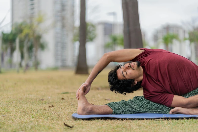 a person stretches while standing in a field