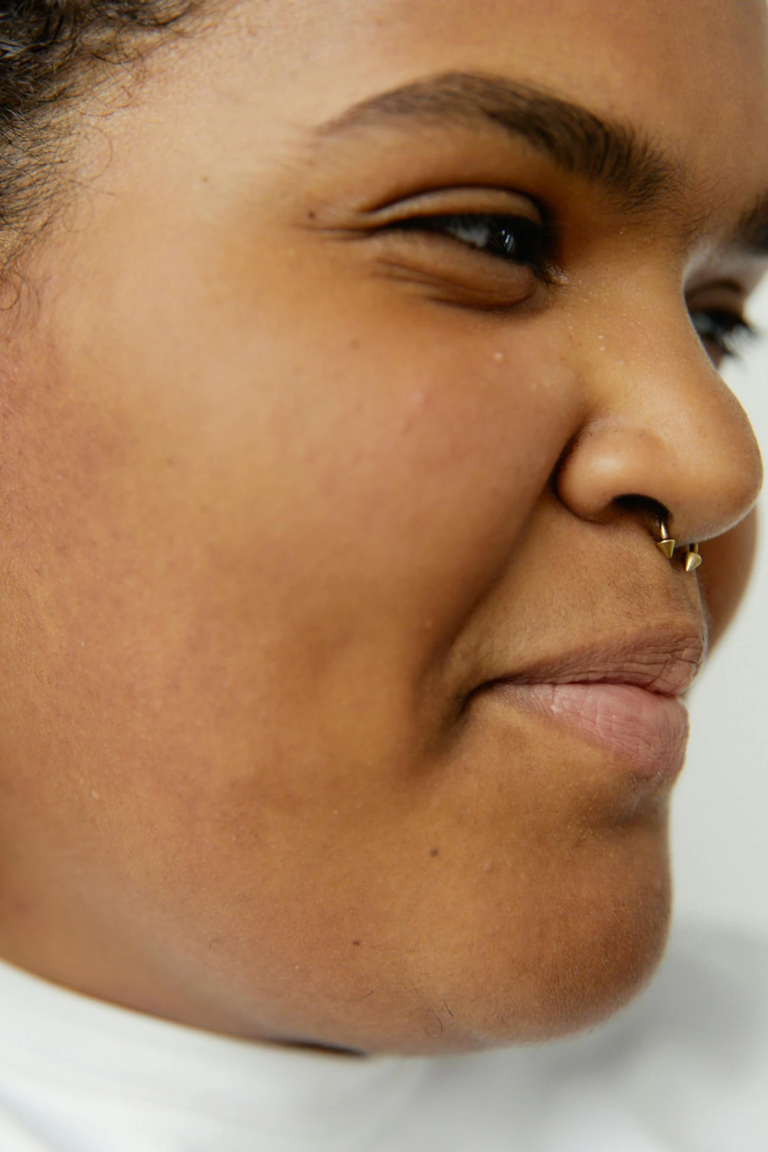 a woman wearing a pair of hoop earrings