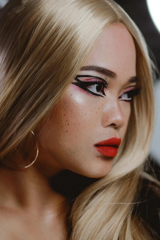 an adult woman with makeup and bright red lipstick