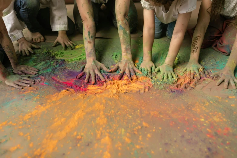 five girls with hands and colorful paint on their hands