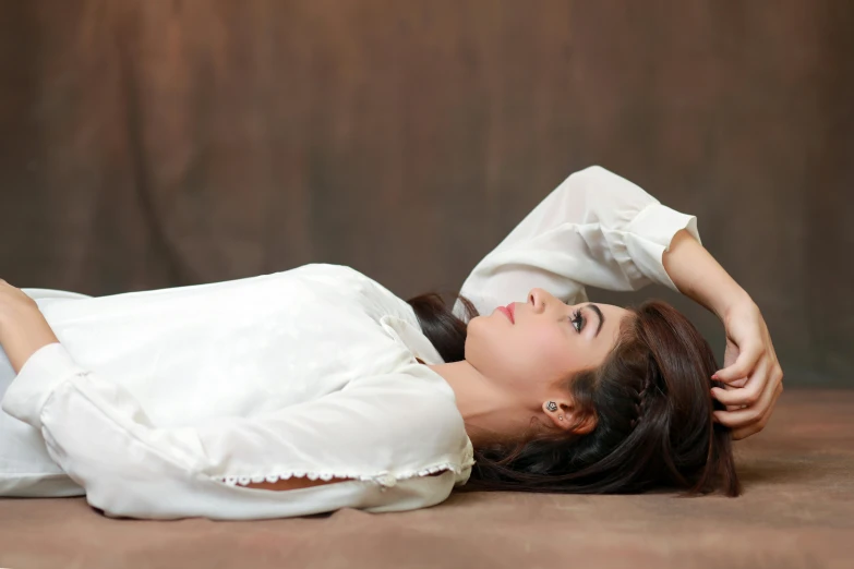 woman with her hands behind her head and looking up