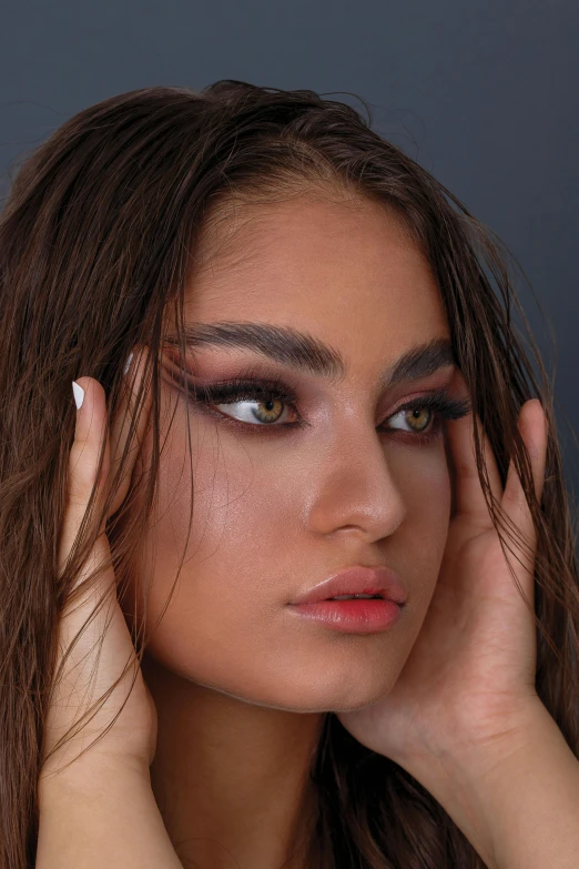 a model has a long, wet hair and eyeshadow