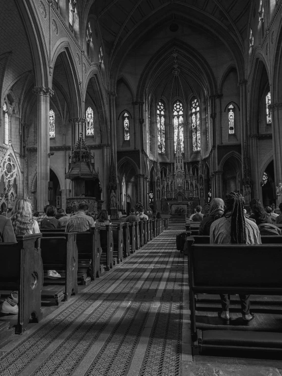 a black and white po of people in church pews